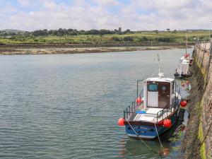 a small boat is docked in the water at Little Valley View in Hayle