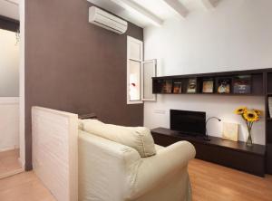 a living room with a white couch and a television at Authentic flat2 in Poble sec - Paralelo in Barcelona