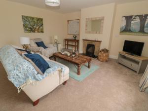 a living room with a couch and a fireplace at The Folly in Newcastle upon Tyne