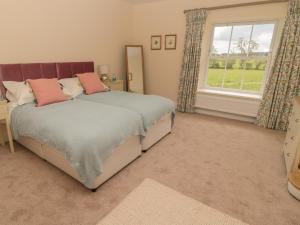 a bedroom with a bed and a window at The Folly in Newcastle upon Tyne