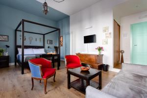 a living room with a bed and a couch and a table at Napoli Bonita b&b in Naples