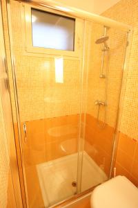 a bathroom with a shower and a toilet with a glass door at Bilocale Orange in Gallipoli