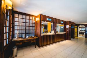 a lobby with wooden walls and a desk in a building at Hotel Morro dos Conventos in Araranguá