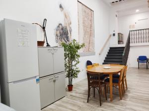 a dining room with a table and a refrigerator at Palafox 23 in Madrid