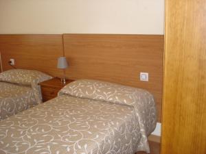 Łóżko lub łóżka w pokoju w obiekcie Pio V