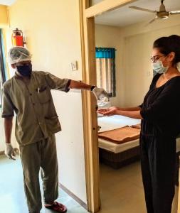 a man and a woman in a room with a bed at Hotel Vaishali in Nashik