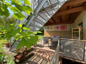 a balcony of a house with a table and chairs at Fuchsbau-Goldbach in Goldbach