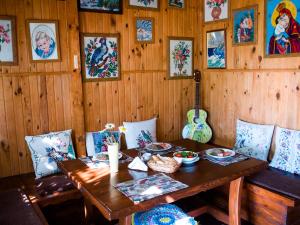 a dining room with a wooden table and a guitar at Vesela Sadyba in Veselivka