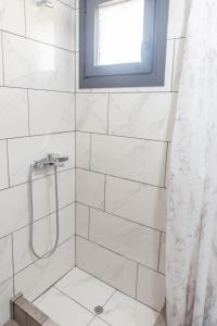 a bathroom with a shower with a window at DNS Apartment in Kavála +13 photos