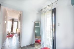 a dressing room with a mirror and a white wall at DNS Apartment in Kavála