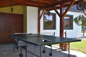 a ping pong table in front of a house at Chalupa Rekreant in Bešeňová