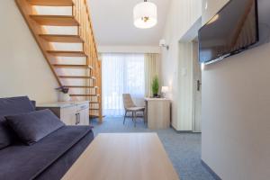 Televízia a/alebo spoločenská miestnosť v ubytovaní Hotel Jan