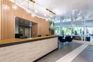 a lobby with a reception desk and chairs in a building at Hotel Jan in Darlowko