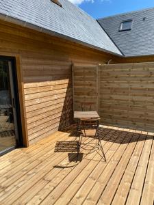 a chair sitting on a deck next to a fence at Les Apparts in Genneville