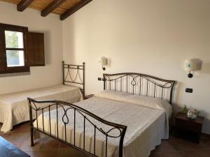 Säng eller sängar i ett rum på Li Paduleddi Country Guest House