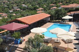 an outdoor swimming pool with umbrellas and a resort at Lacivert Boutique Hotel in Selimiye