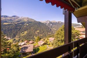 a view of a mountain range from a window at Chalet Primula Penthouse in Wengen