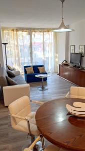 a living room with a table and a couch at Family apartment in Riccione, free bikes in Riccione