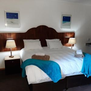 A bed or beds in a room at Wayside Lodge