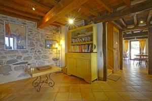 uma sala de estar com uma estante de livros e uma mesa em Les gerbes em Arras-en-Lavedan