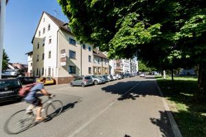 a person riding a bike down a street at Hotel zur Post in Heilbronn