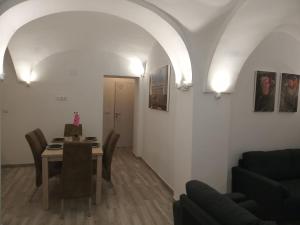a living room with a table and a dining room at Alojamientos rurales La Barca del tío Vito in Peloche
