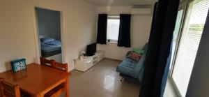 a living room with a table and a dining room at Apartment MINT in Senec