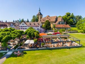 an aerial view of a resort with people sitting at tables at Hotel Rotes Kreuz in Arbon