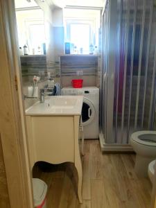 a small bathroom with a sink and a toilet at Apartment Mary in Terracina +13 photos