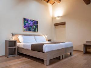 コラ・ディ・ラツィーゼにあるLe Palazzoleのベッドルーム1室(壁に絵画が描かれたベッド1台付)