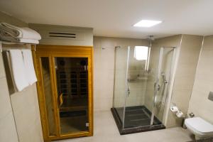 a bathroom with a shower and a toilet at Ramada Plaza By Wyndham Izmir in İzmir