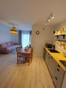 a kitchen and living room with a table and a dining room at Studio Sopot Twins in Sopot