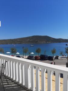 a white balcony with a view of a body of water at Apartments La Mare in Primošten +5 photos