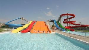 a water park with a water slide in the water at Apartment MINT in Senec