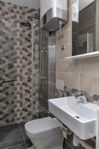 a bathroom with a toilet and a sink and a shower at Lux Dado Igrane in Igrane