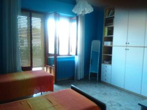 A bed or beds in a room at Appartamento in zona tranquilla a 400m dal mare