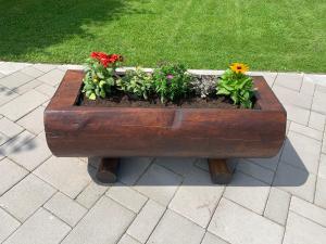 a wooden planter with flowers in it on a patio at Miroslav Bednár-Bedomir in Huta