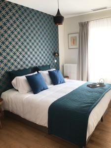 a bedroom with a large bed with a blue wall at Les Terres Rouges 06 in Guillaumes