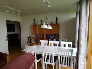 a dining room with a white table and chairs at Miðjanes Reykhólahrepp in Reykhólar