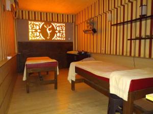 a room with two beds and a chair and a window at Halıcı Hotel Resort & SPA in Pamukkale +14 photos