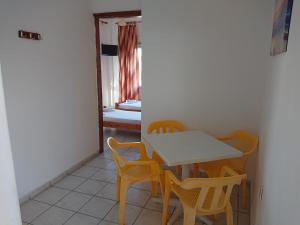 a dining room with a table and chairs and a bedroom at House Papus in Sarti +14 photos