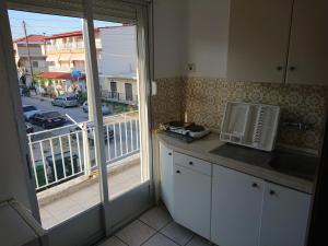 a kitchen with a window with a view of a street at House Papus in Sarti
