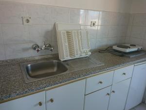 a kitchen counter with a sink and a toaster at House Papus in Sarti