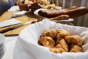 a bowl of pastries sitting on a table at Maloja Palace Suites CO2-Neutral in Maloja +185 photos