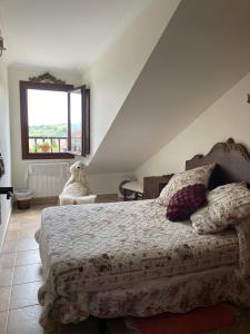a bedroom with a bed and a large window at Posada de Seña in Seña