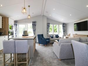 a kitchen and living room with a couch and a table at Pinehurst Lodge in Redruth