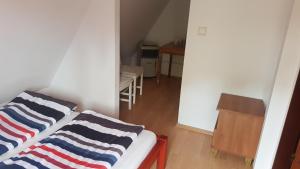 Postel nebo postele na pokoji v ubytování Alex Inn