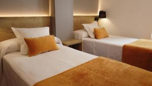 Posteľ alebo postele v izbe v ubytovaní Hotel La Bonaigua