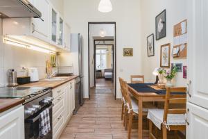 a kitchen with a table and a dining room at Homely 4 Bedroom Apartment - Old Town in Krakow