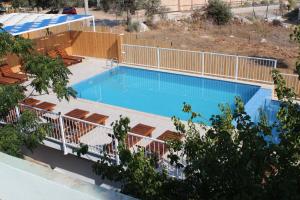 an overhead view of a swimming pool with a deck and a fence at Patara Caretta Hotel in Patara